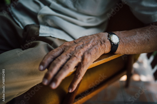 Close up of senior man hand with a watch photo