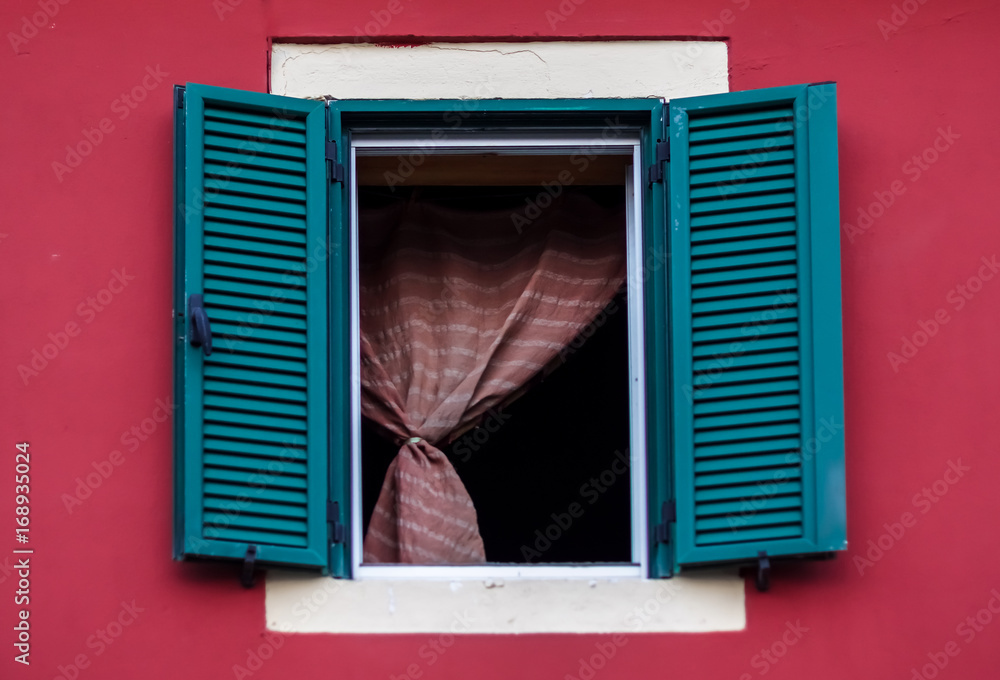 Fototapeta premium Green window on a red building