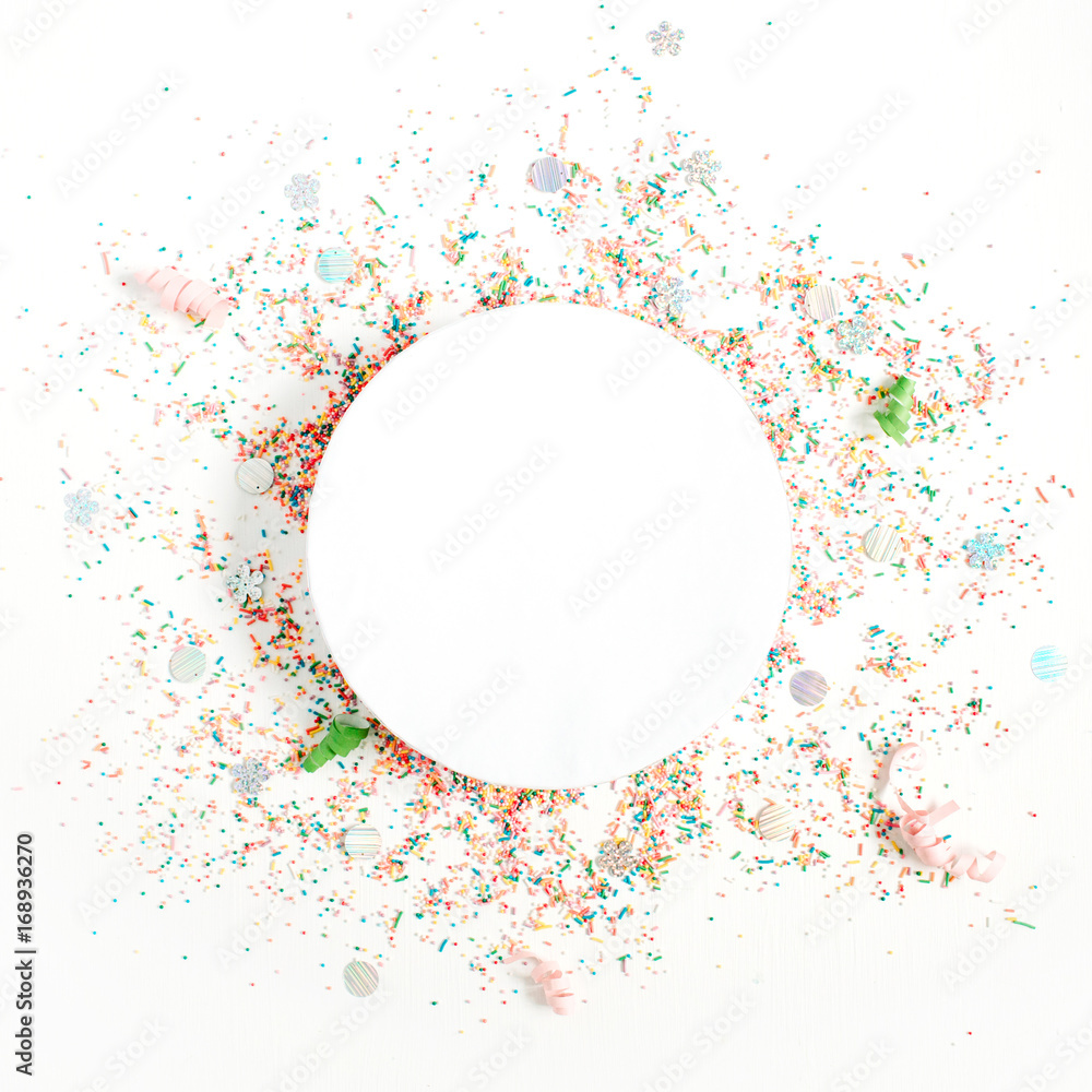 Creative round layout with copy space made of colorful confetti on white background. Celebration concept background. Flat lay, top view.