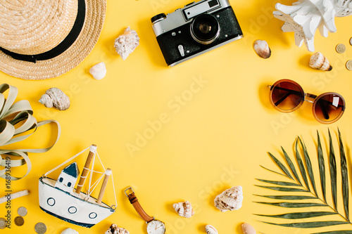 Flat lay traveler accessories on yellow background with blank space for text. Top view travel or vacation concept. Summer background.