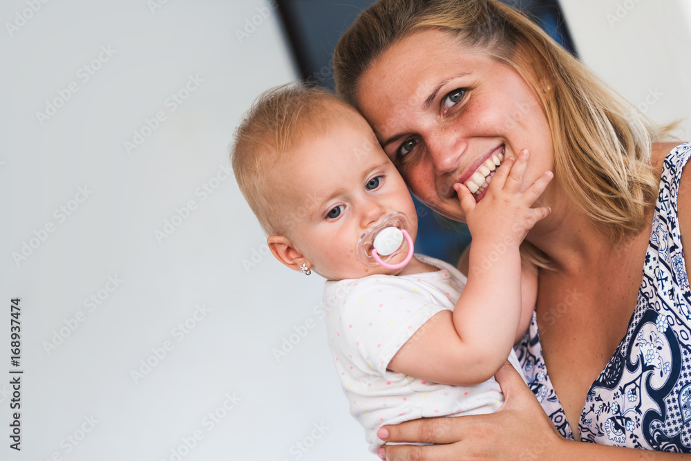 Portrait of smiling mother holding her baby Portrait of smiling mother holding her baby