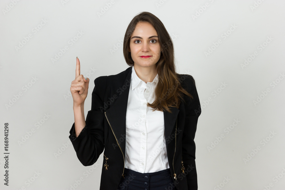 Young happy young businesswoman pointing up to product Young happy young businesswoman pointing up to product