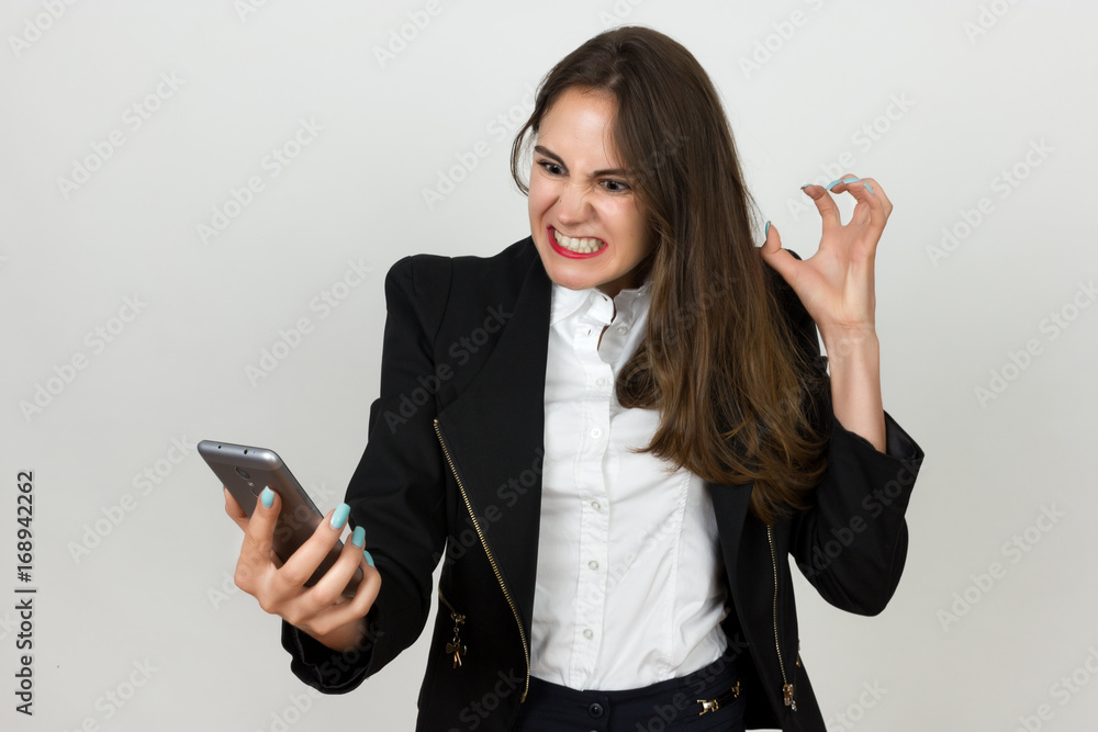 Young businesswoman using a cell phone and scream Young businesswoman using a cell phone and scream