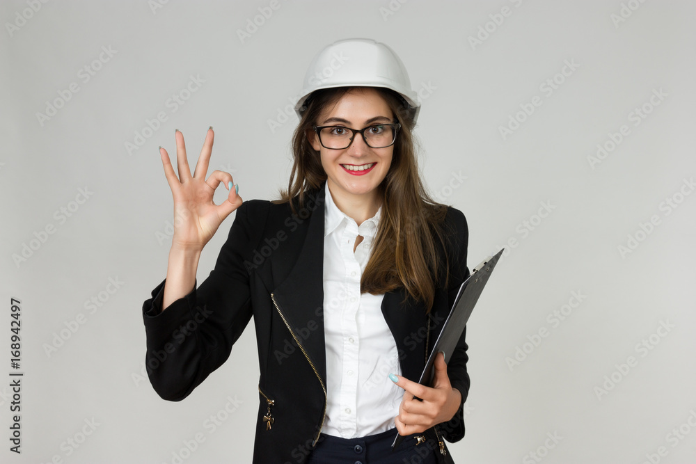 Young businesswoman or engineer showing ok sign Young businesswoman or engineer showing ok sign
