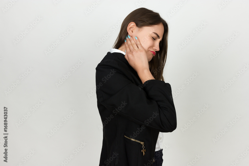 Portrait of a pretty young businesswoman holding her neck in pain and discomfort