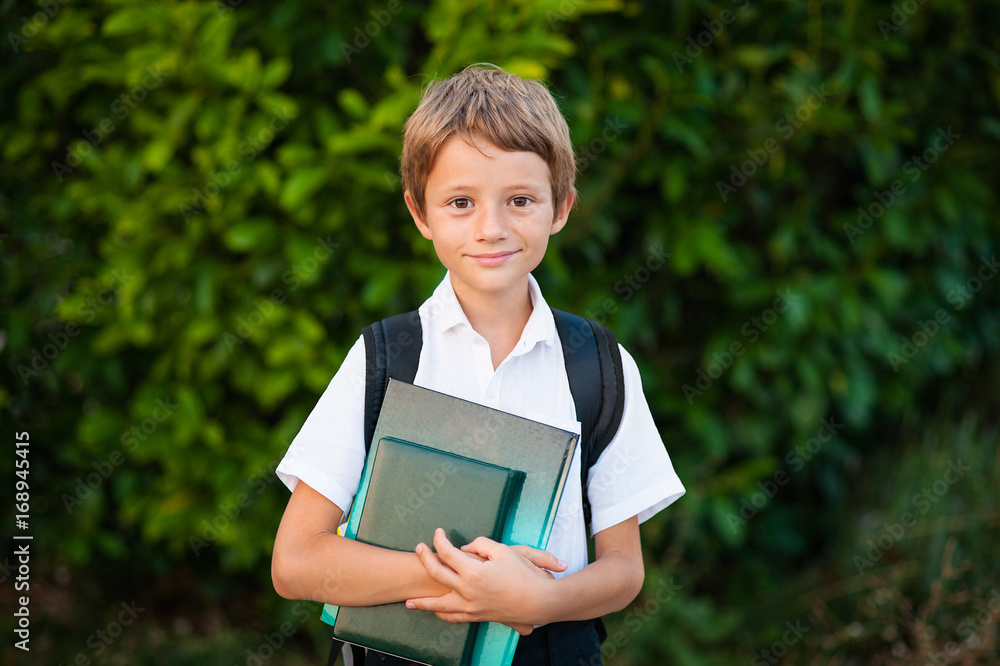 Smiling schoolboy with school bag running in sunny day. Boy going home from school. Smiling schoolboy with school bag running in sunny day. Boy going home from school.