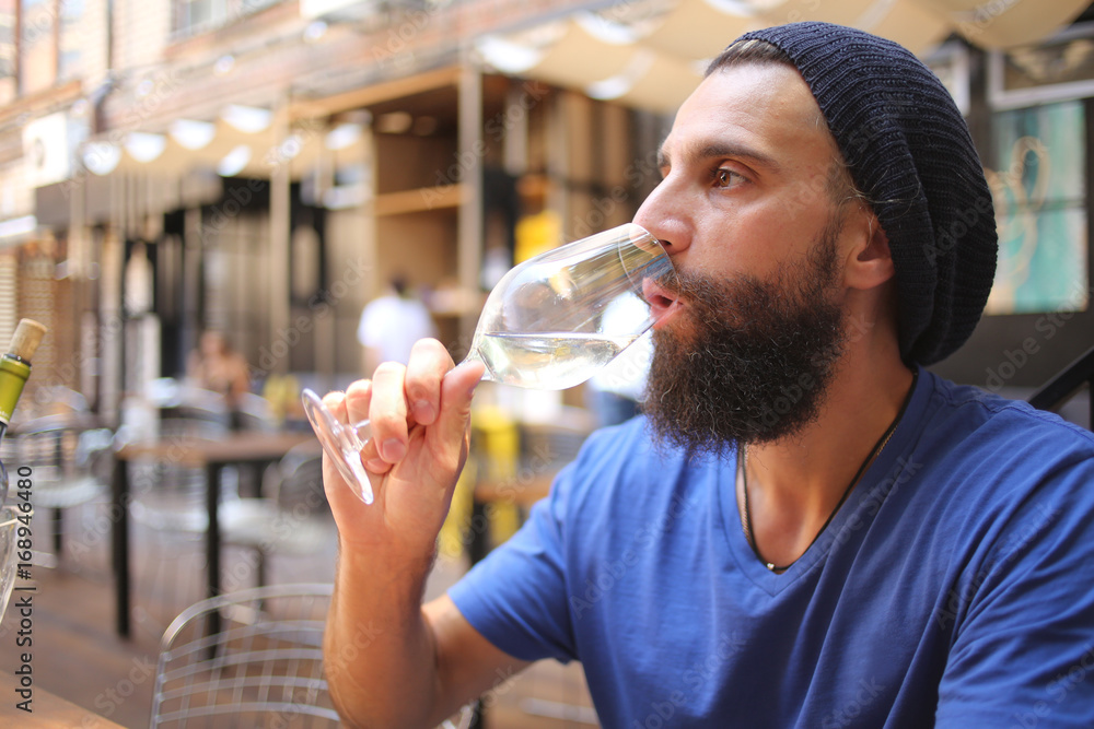 Fototapeta premium Bearded man drinking wine