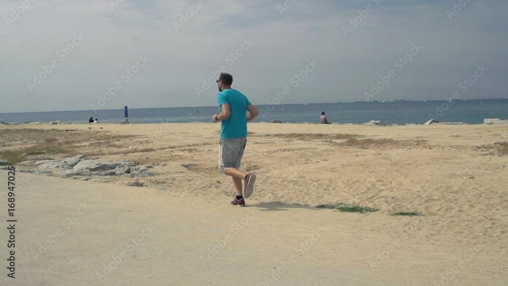 Young man jogging near beach in city, super slow motion 240fps
Young man jogging near beach in city, super slow motion 240fps
