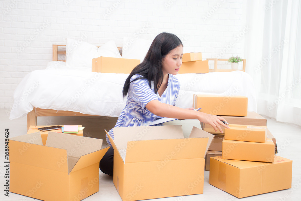 Young asian woman business owner work and white down address for deliver at home, woman SME business owner concept, 20-25 year old.. Young asian woman business owner work and white down address for deliver at home, woman SME business owner concept, 20-25 year old..