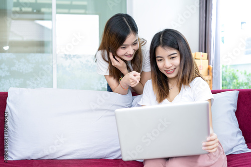 Young asian girl together teamwork freelancer business private working at home office using laptop packaging delivery online market on purchase checking orders to customer.