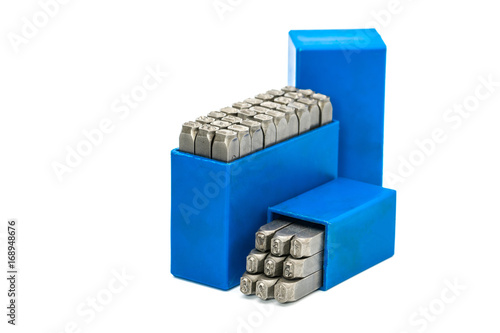 Set of metal stamp alphabet and number punch in blue plastic box isolated on white background with copy space