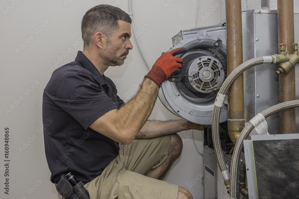 Hvac repairman installing motor and casing Hvac repairman installing motor and casing