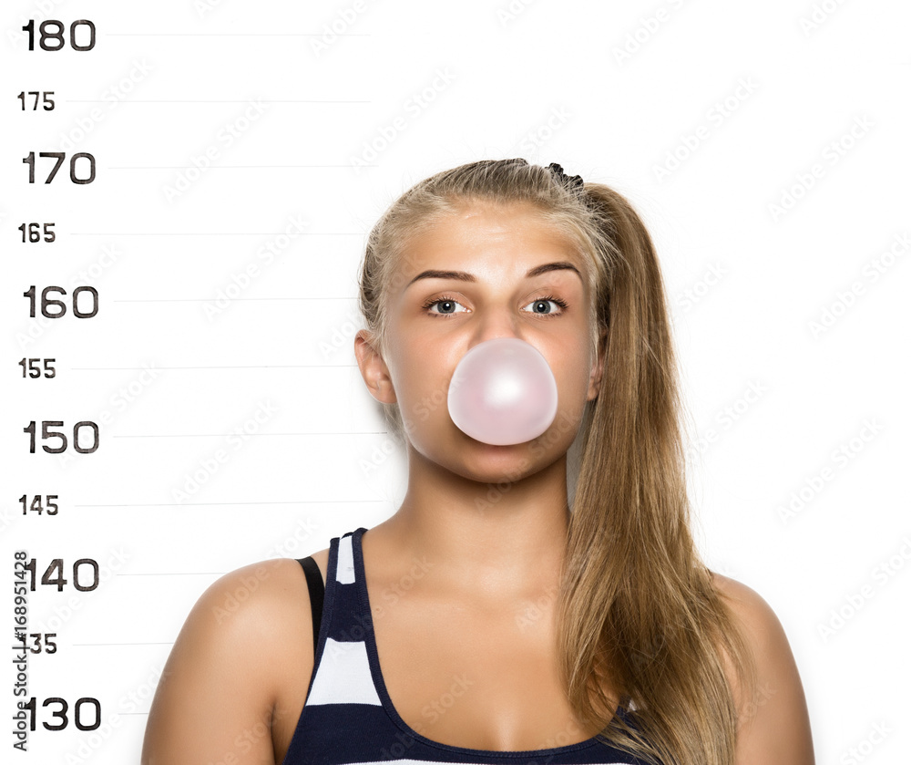 Young beautiful blonde woman chewing gum and blowing bubbles Criminal ...