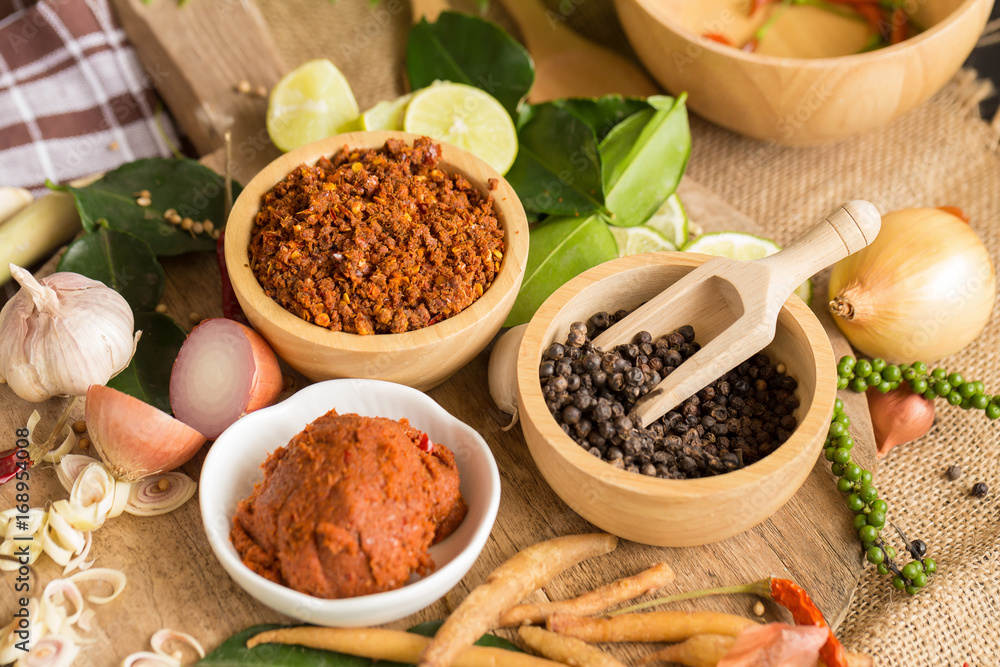 Assortment of Thai food Cooking ingredients. Spices ingredients chilli pepper garlicgalanga and kaffir lime leaves Assortment of Thai food Cooking ingredients. Spices ingredients chilli pepper garlicgalanga and kaffir lime leaves