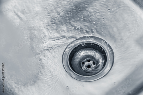 Fotografie Water rinse in Kitchen Stainless steel sink hole