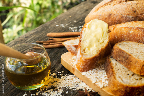 Freshly baked traditional Italian Cibatta bread cut in slices on a wooden table photo