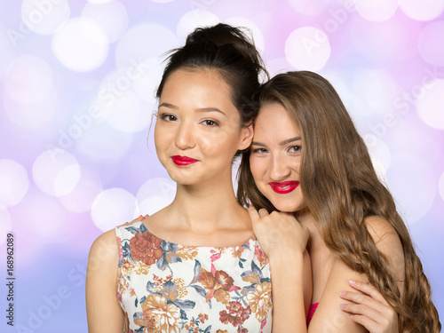 Two young girl friends standing together and having fun © fotofabrika