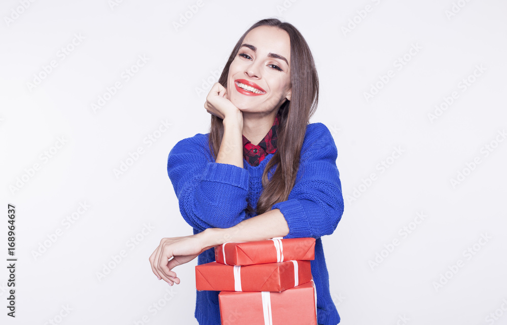 Beautiful brunette woman smiling with a red gift boxes in hands isolated on the white background. Beautiful brunette woman smiling with a red gift boxes in hands isolated on the white background.