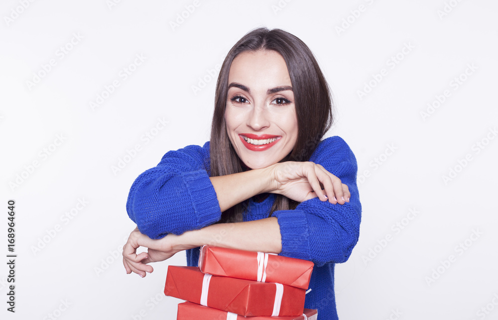 Beautiful brunette woman smiling with a red gift boxes in hands isolated on the white background. Beautiful brunette woman smiling with a red gift boxes in hands isolated on the white background.