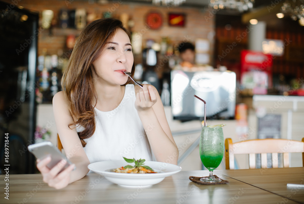 Young Asia woman eating spaghetti at restaurant