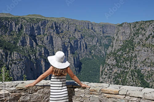 girl with white hat on the viewpoint Vikos gorge Greece