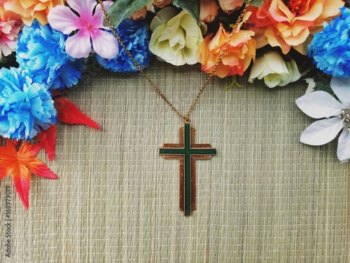 Christian Cross with various colorful flowers decoration photo