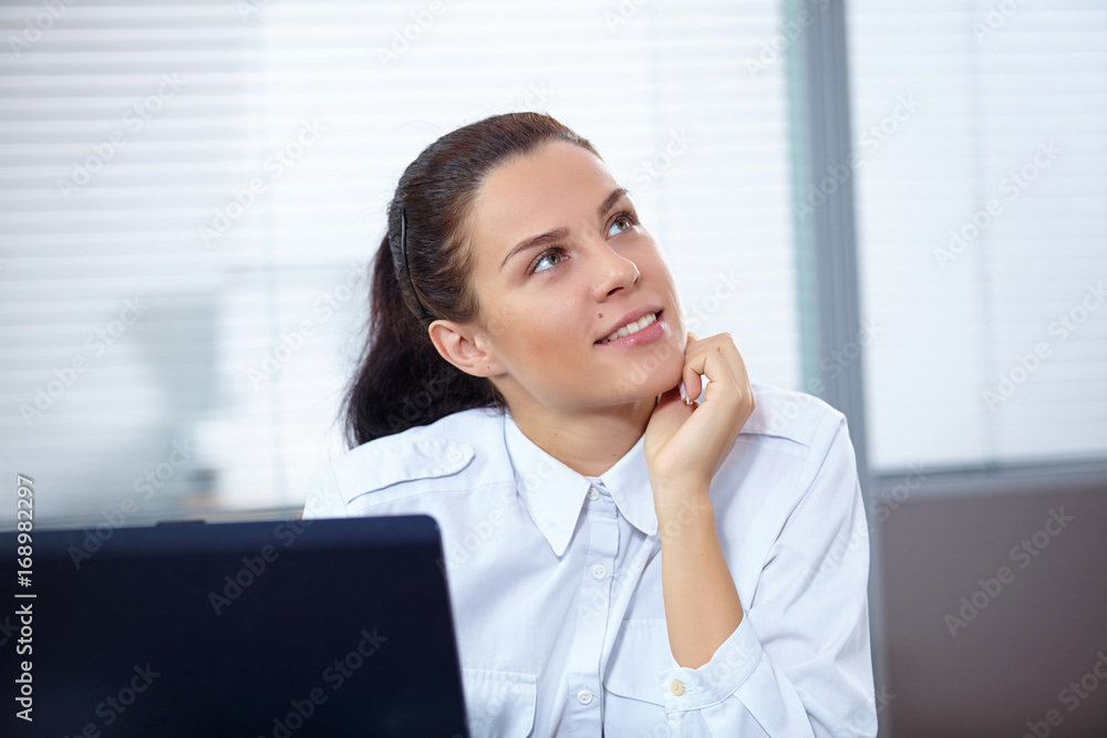 Young businesswoman sitting at workplace