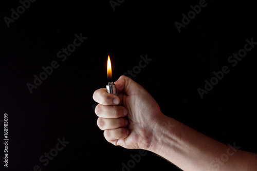 hand holding a lighter in a dark atmosphere