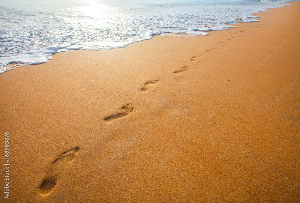 beach, wave and footprints at sunset time beach, wave and footprints at sunset time