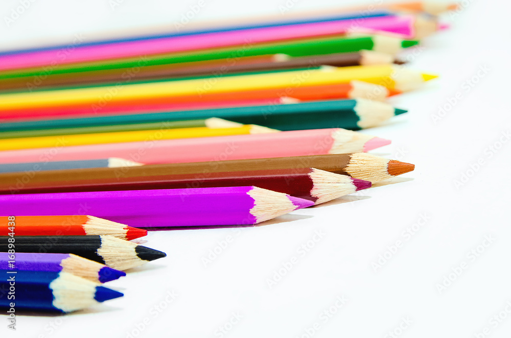Colored pencils on white background. Close-up. Colored pencils on white background. Close-up.