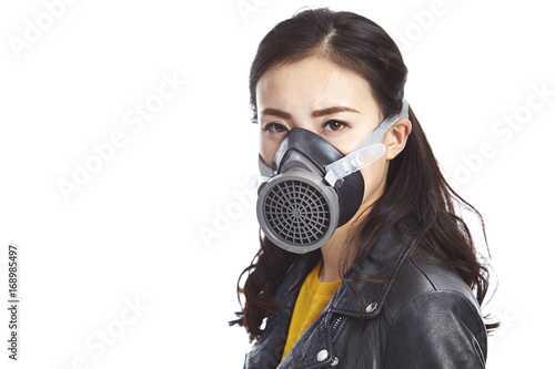 young asian woman wearing a gas mask