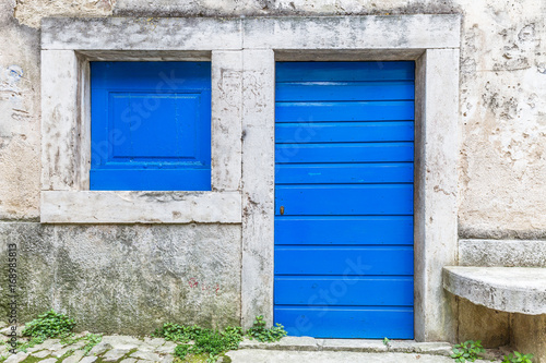 Blue entrance door to a house on stone street in Istria, Croatia, Europe.