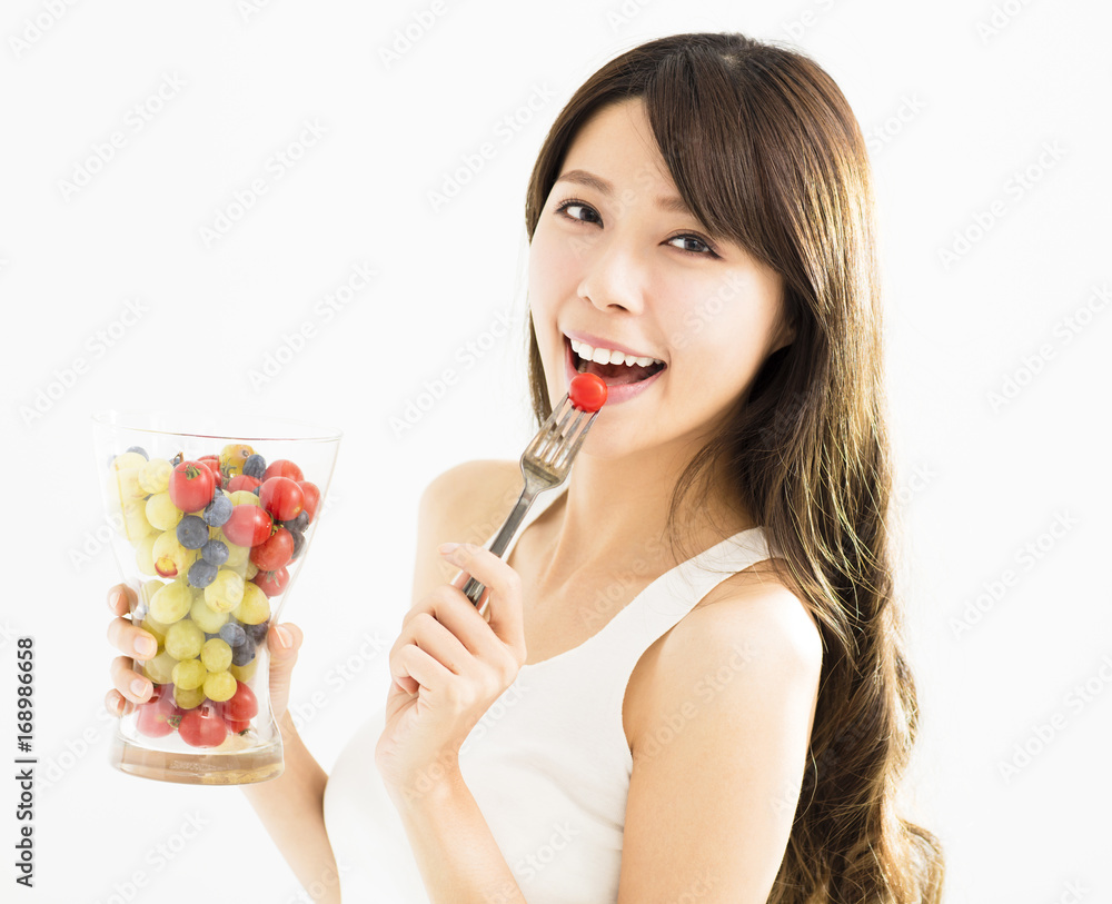 Happy young woman eating fresh fruits. Happy young woman eating fresh fruits.