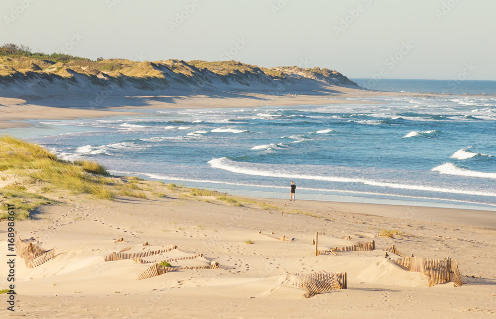 A Girl walk alone in Cabedelo Beach at morning, Viana do Castelo, Portugal.