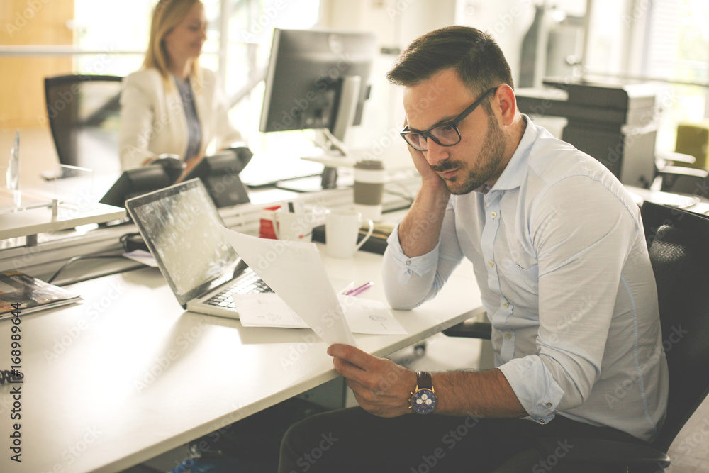 Fototapeta premium Business people working. Business man reading document an thinking.