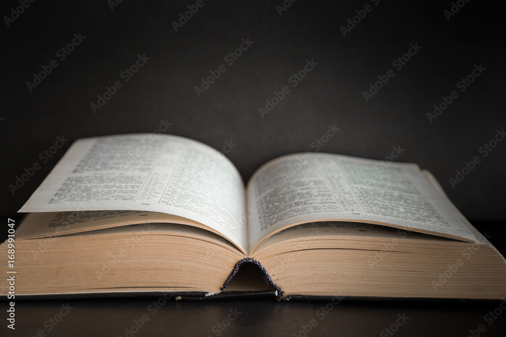 Opened bible in the quiet, dark atmosphere. Prayer time on sunday. Opened bible in the quiet, dark atmosphere. Prayer time on sunday.