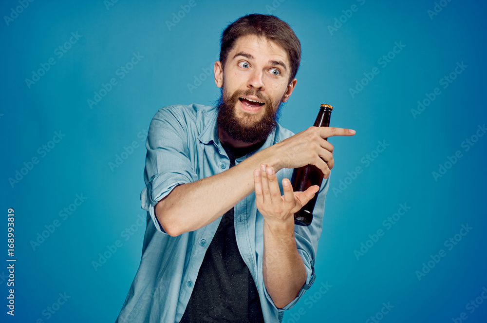 1368114 Man holding a bottle of beer 1368114 Man holding a bottle of beer