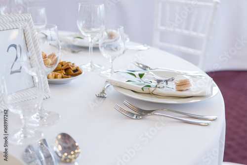 table setting with spoon, knife, plates and glass