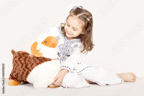 Happy little girl playing with her sheep toy - celebrating Eid ul Adha - Happy Sacrifice Feast photo