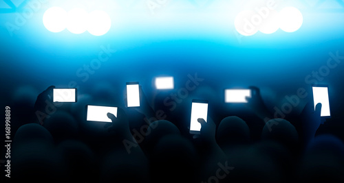 A crowd of people shooting a concert on the phones. Vector illustration
