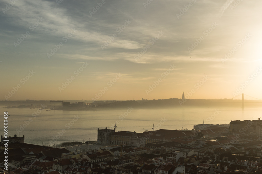 Views of Lisbon at sunset with mist in the horizon