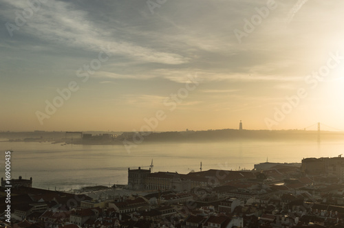 Views of Lisbon at sunset with mist in the horizon © Adrin