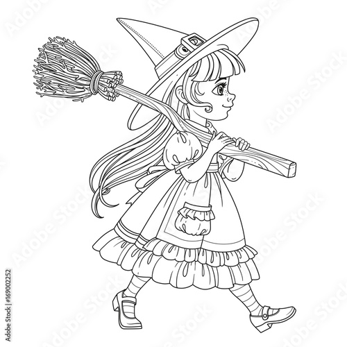 Cute girl in witch suit goes forward holding a broom for flights