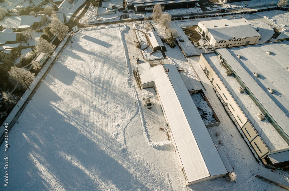 Aerial photo in winter, hall in the snow from sloping point of view