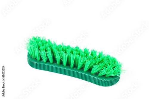 green cleaning brush on white background