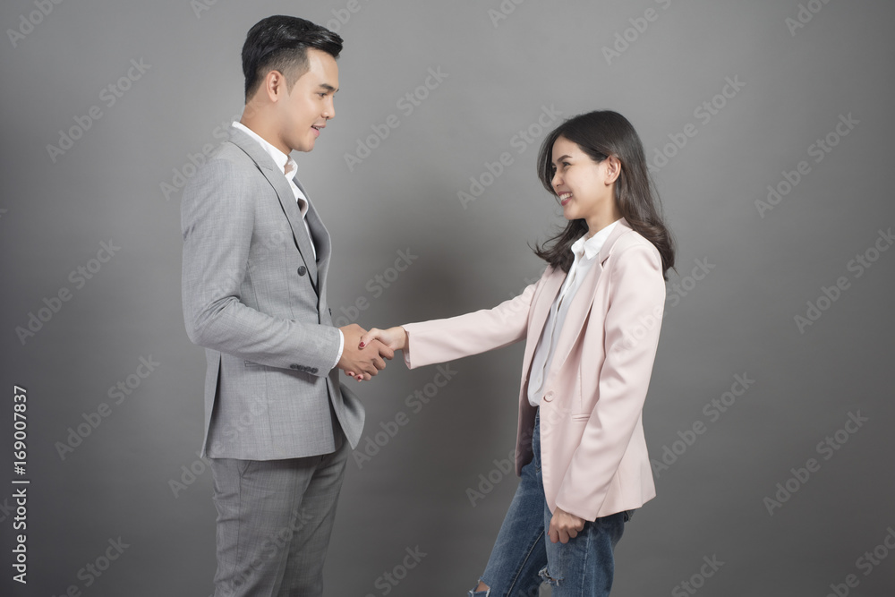 Businessman and businesswoman are shaking hands,Business plan and business meeting concept Businessman and businesswoman are shaking hands,Business plan and business meeting concept