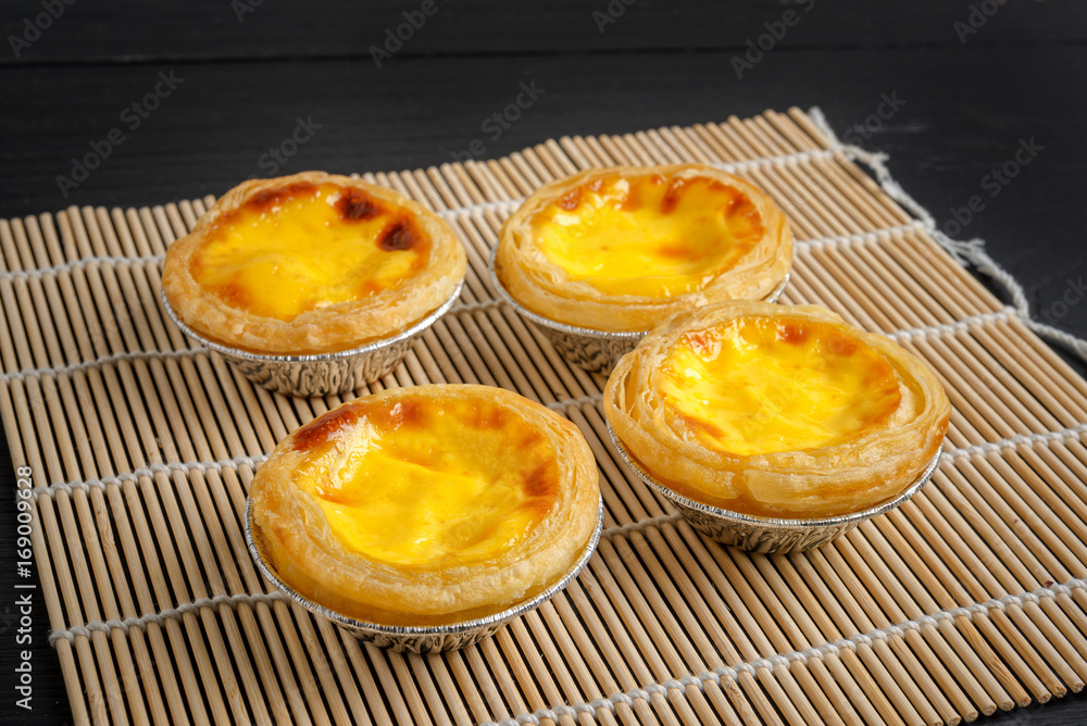 egg tart on black wood egg tart on black wood