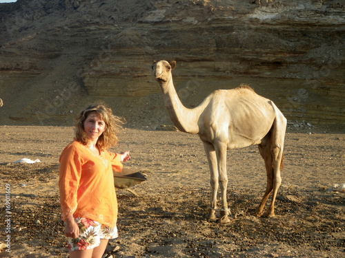 Woman and arican camel photo