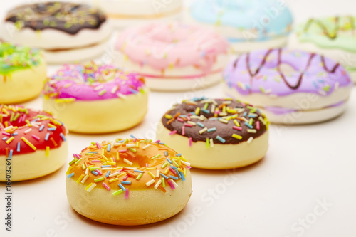 Colorful doughnut on white background table © Lau