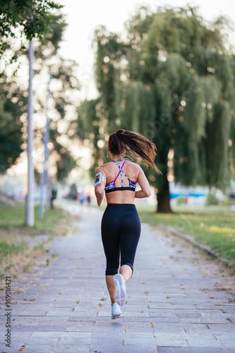 Fototapeta Naklejka Na Ścianę i Meble -  Beautiful athletic woman running outdoors
